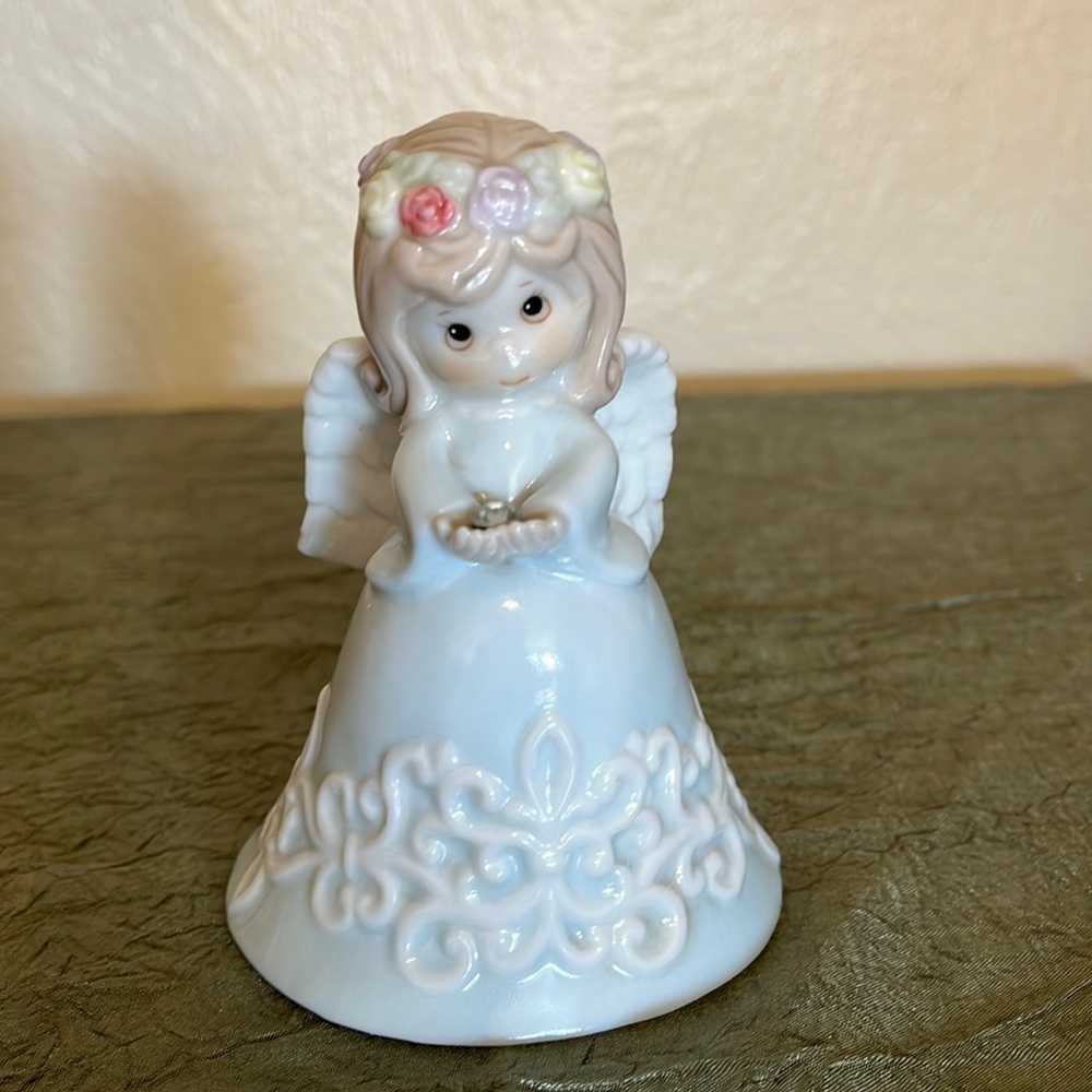 Angel bell, Angel holds April birthstone, 4.25”T, 3”W, porcelain.